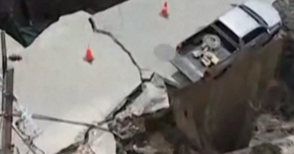 The sinkhole swallows the vehicle and electric pole